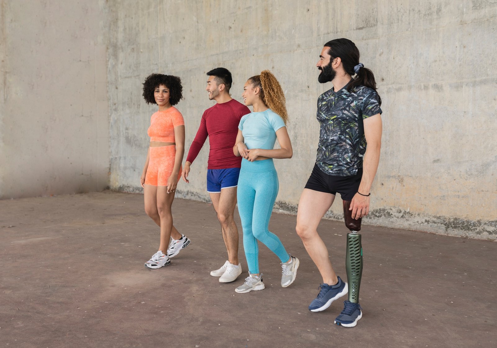 group of sporty multiracial friends in the city, disabled man with prosthesis